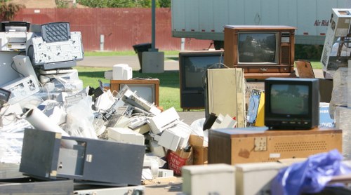 Inspector conducting a written risk assessment at a garden clearance site